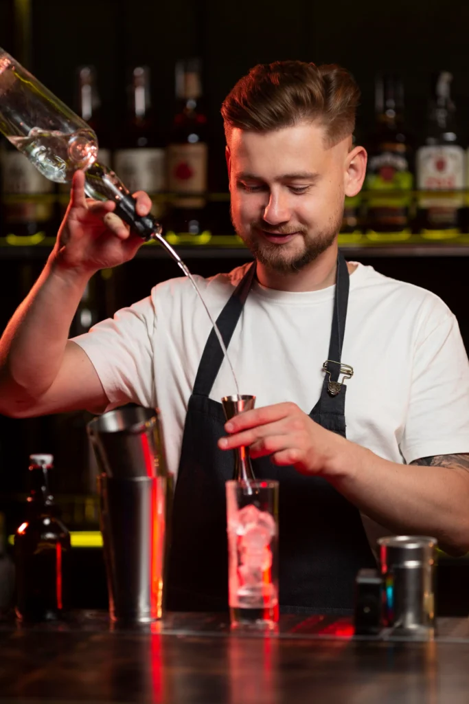 bartender making cocktail with shaker