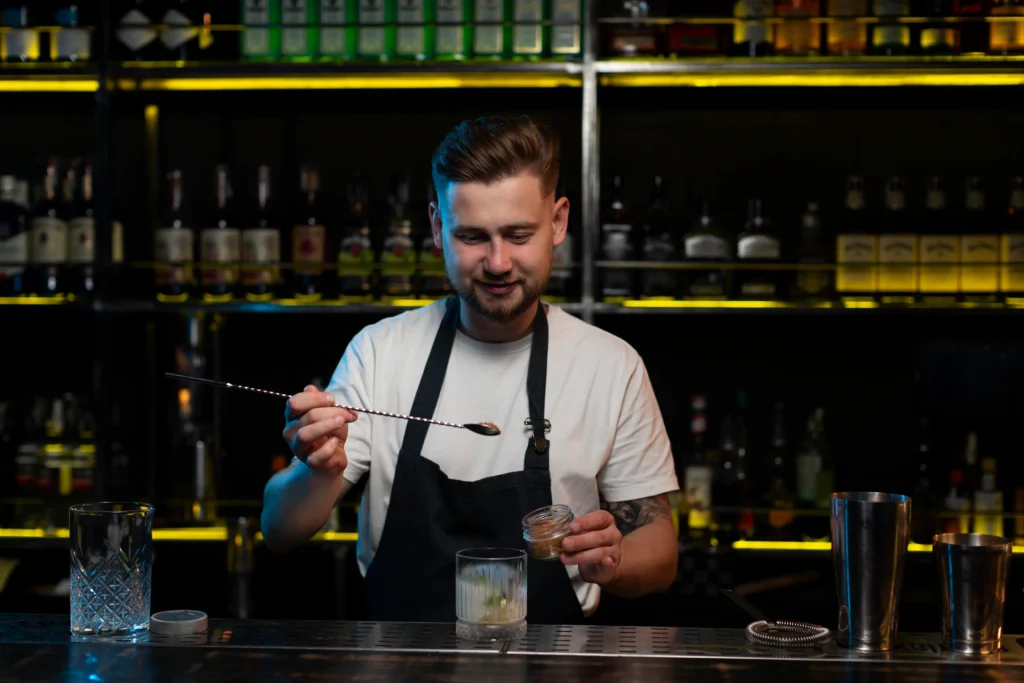 male bartender making delicious cocktail